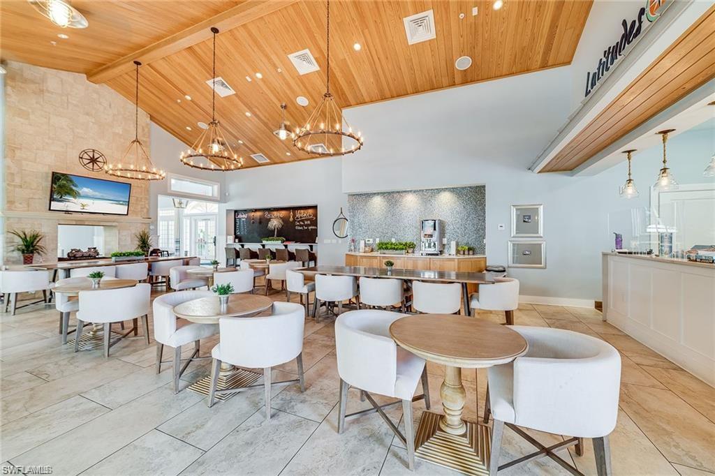 Tiled dining room featuring wood ceiling, high vaulted ceiling, beamed ceiling, and a notable chandelier