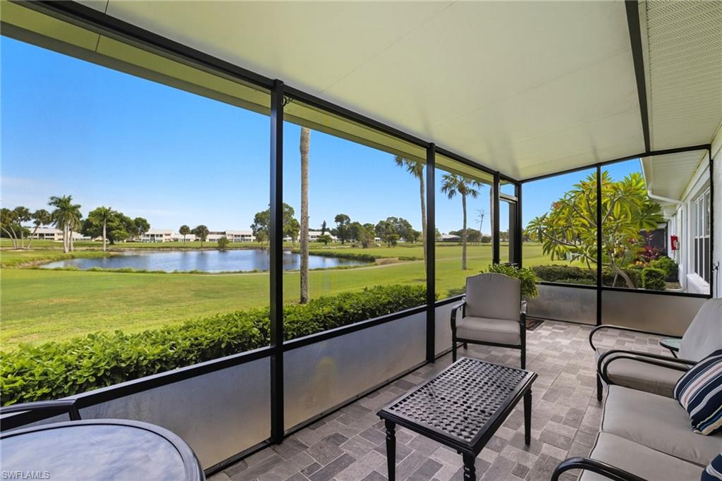 Screened lanai featuring patterned tile flooring and a white paneled ceiling