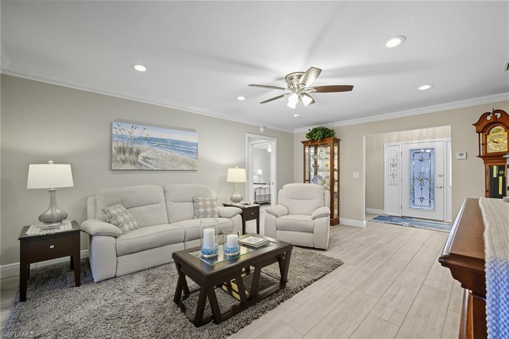 Living area featuring wood-finish flooring, recessed lighting, and a ceiling fan
