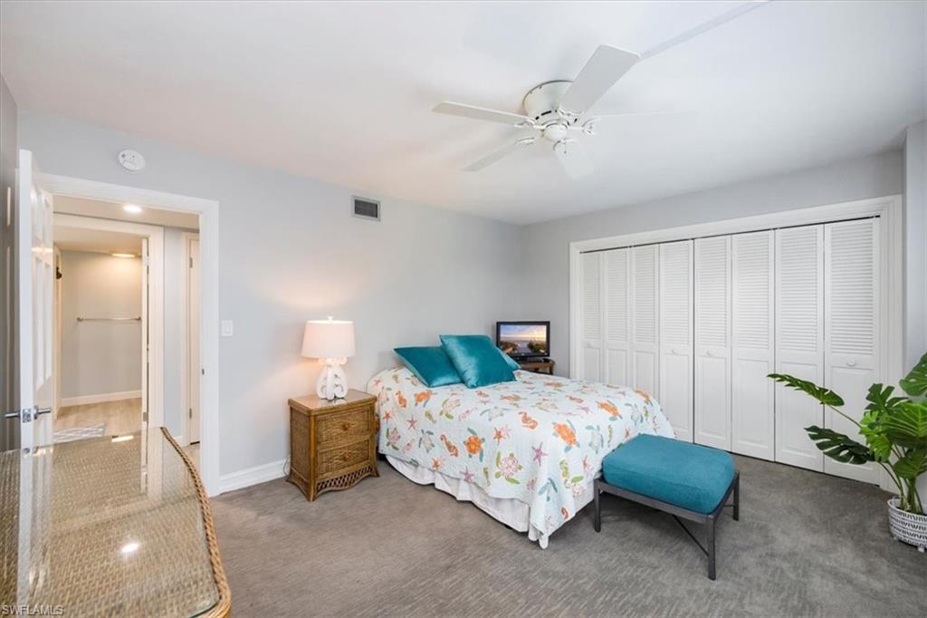 Bedroom with a closet, a ceiling fan, and carpet floors