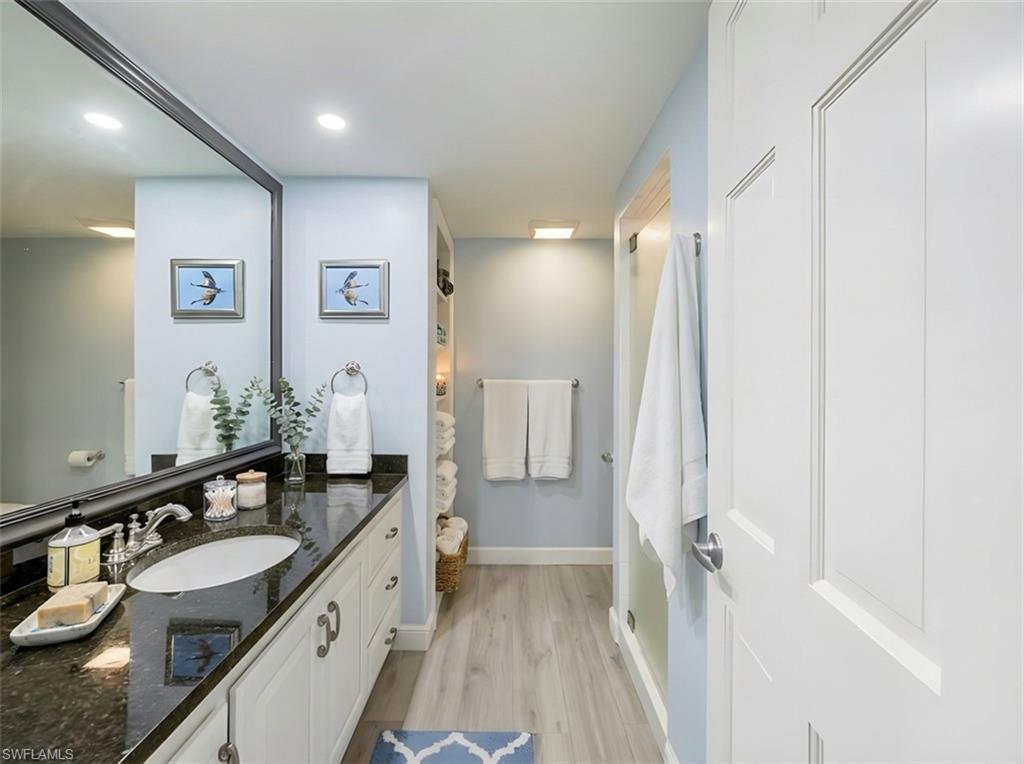 Bathroom with vanity, light wood-style floors, and recessed lighting
