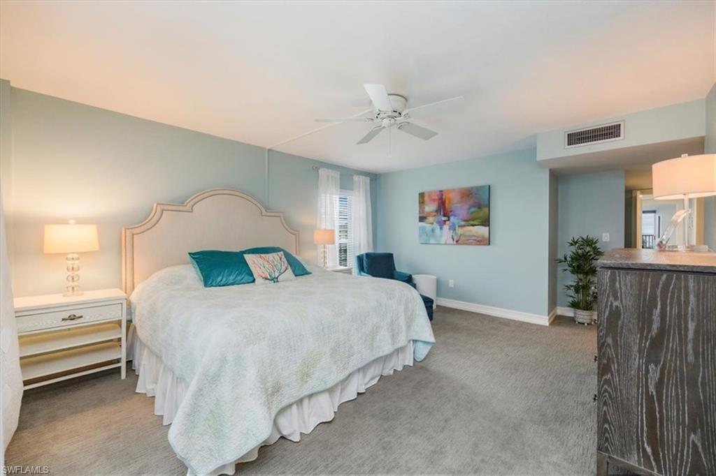 Bedroom with light carpet and a ceiling fan