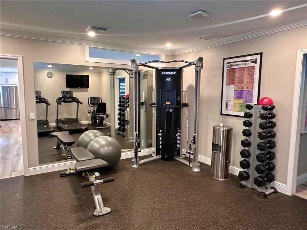 Exercise room featuring crown molding and recessed lighting