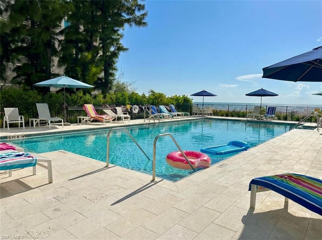 Community pool with a patio