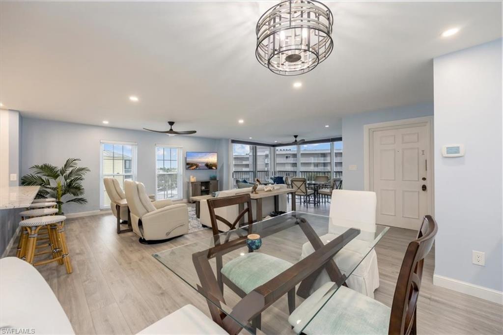 Dining space featuring plenty of natural light, recessed lighting, light wood-style floors, and a chandelier