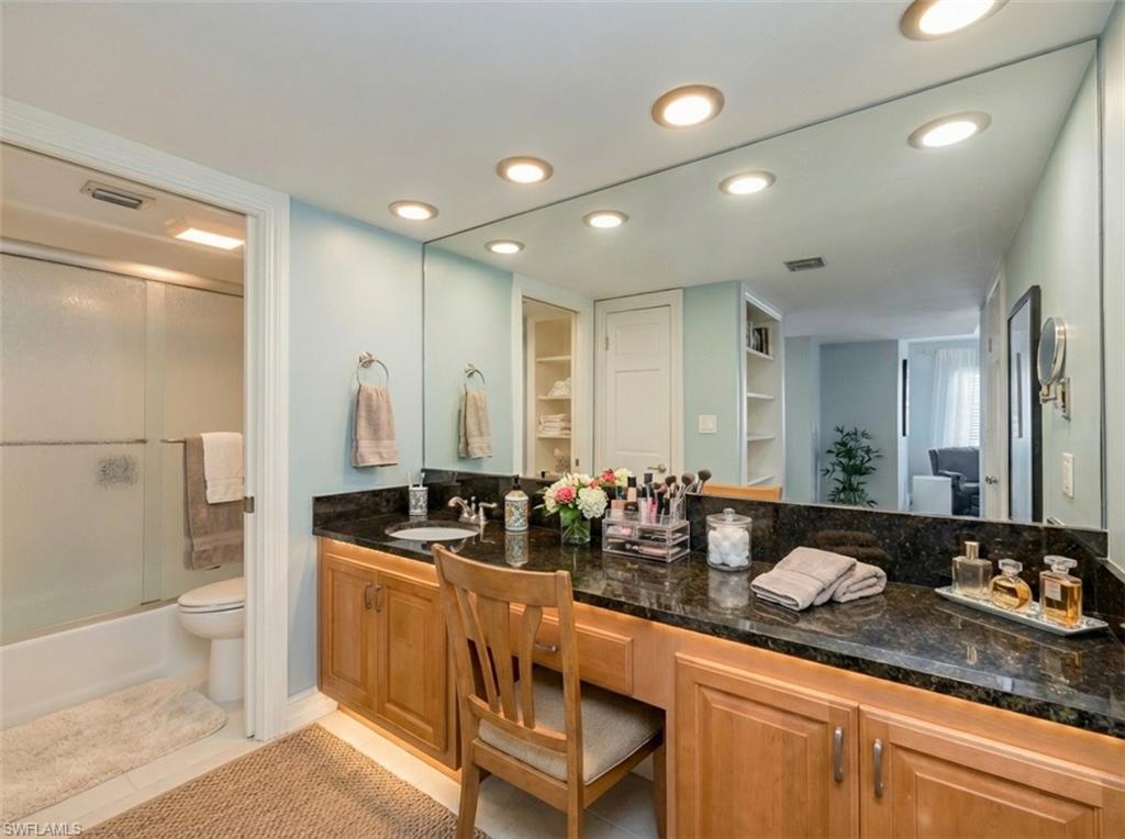 Full bathroom featuring vanity, combined bath / shower with glass door, recessed lighting, and built in features