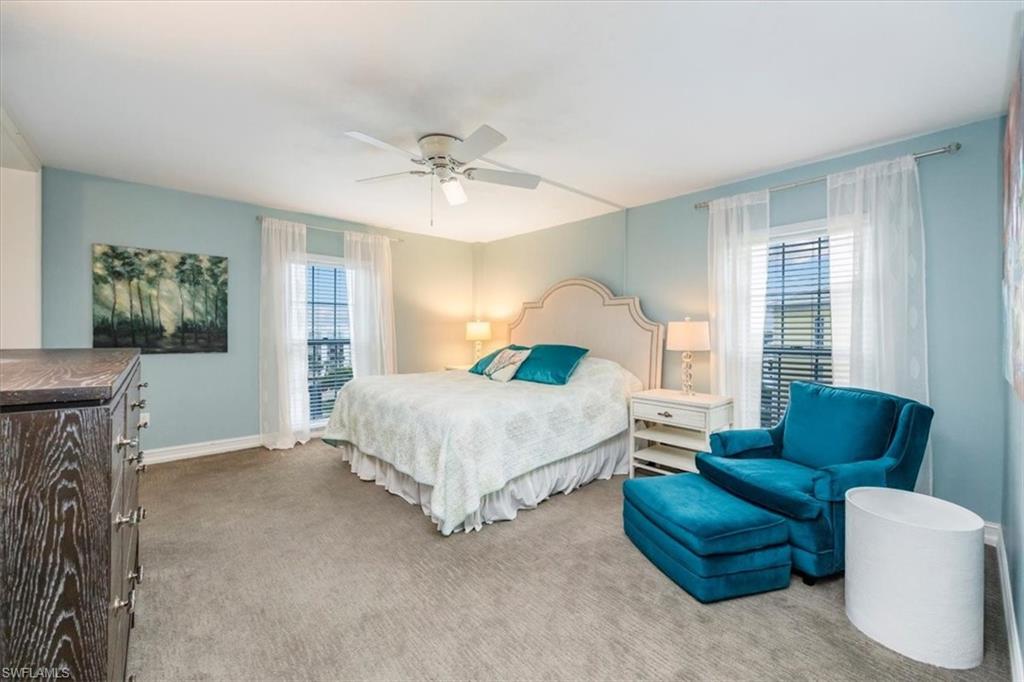 Bedroom featuring carpet, multiple windows, and a ceiling fan