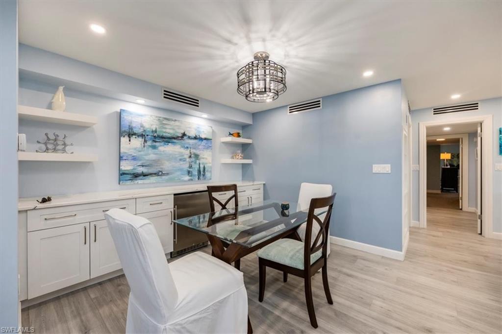Dining area featuring recessed lighting, light wood-style floors, and a chandelier