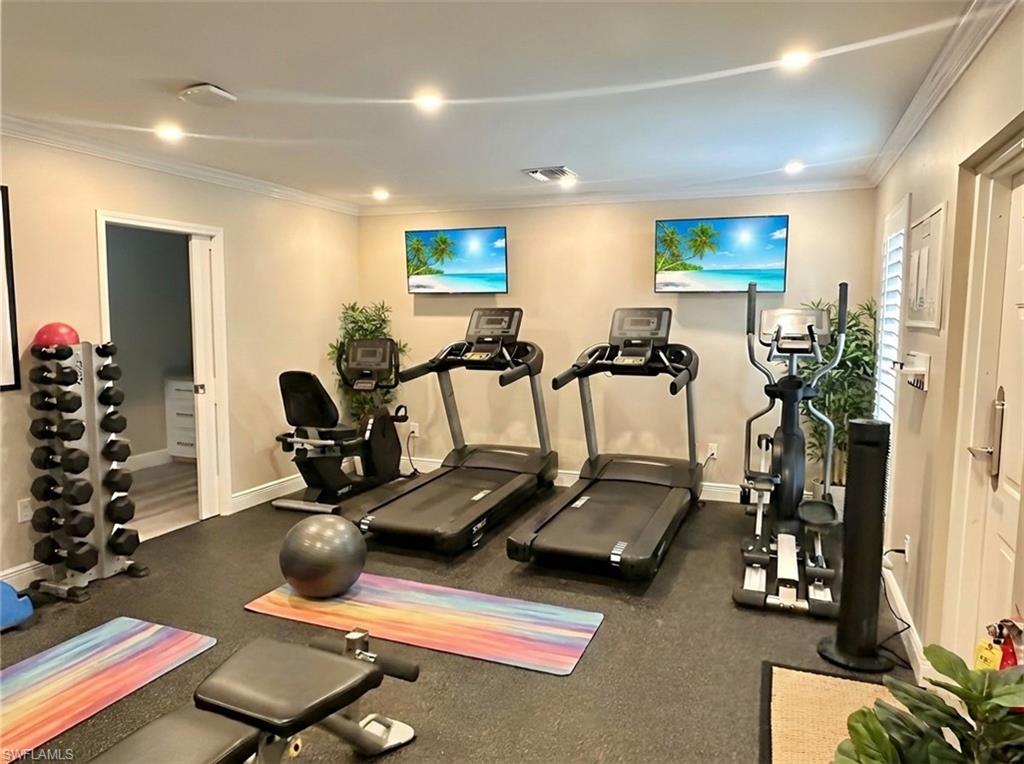 Workout area featuring ornamental molding