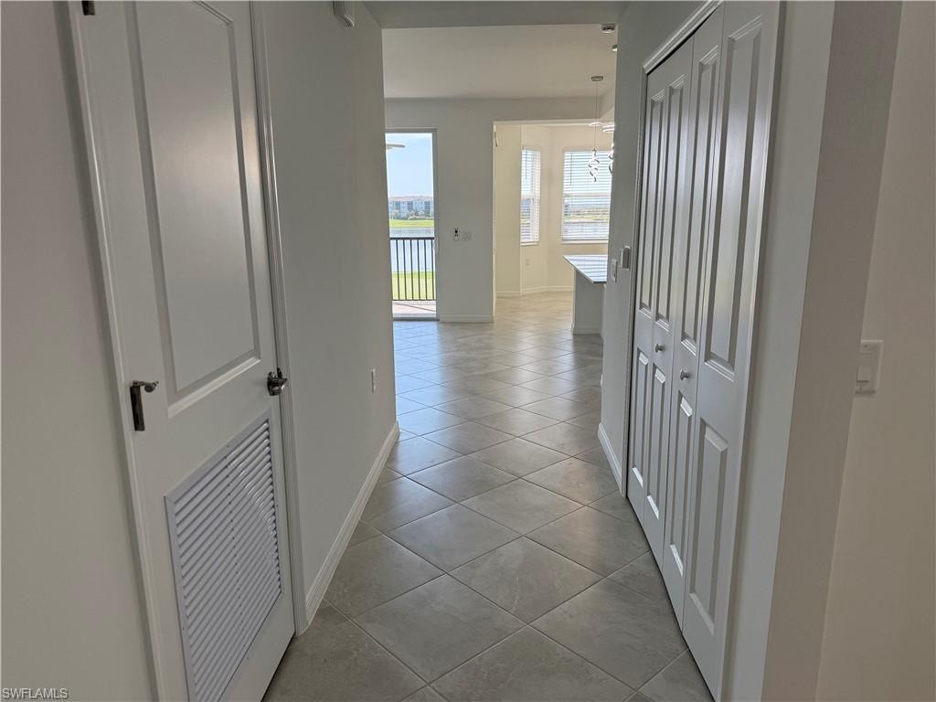 Hallway to living room, dining area, and kitchen
