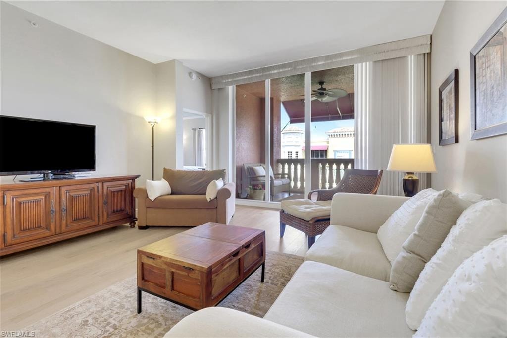Living area with light wood-style flooring and a ceiling fan