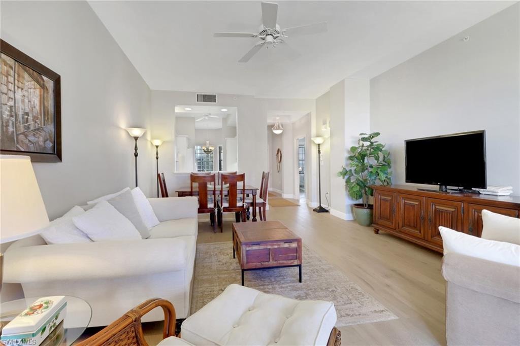 Living area featuring light wood-style floors and a ceiling fan