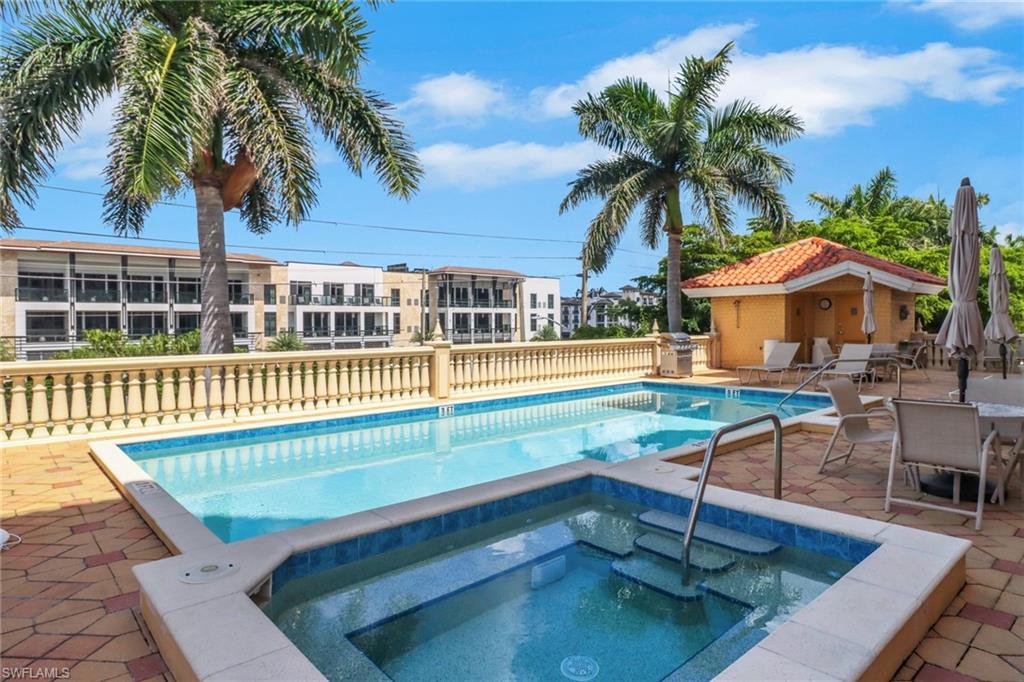 Community pool with a community hot tub and a patio