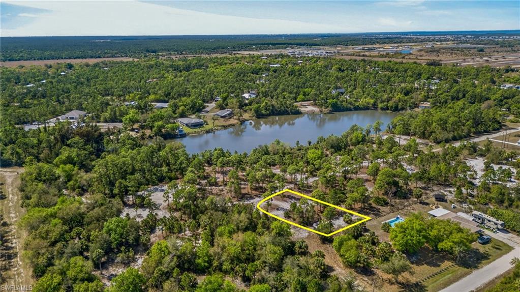 Aerial overview of property's location with property boundaries highlighted and a nearby body of water