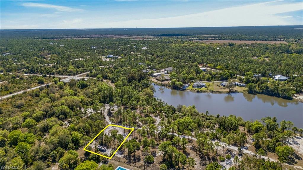 Aerial overview of property's location with property parcel outlined and a large body of water