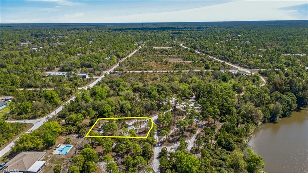 Aerial view of property's location featuring property parcel outlined and a large body of water