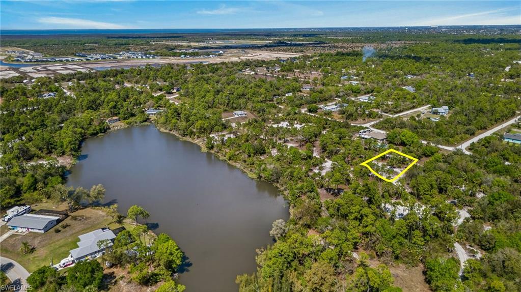 Aerial overview of property's location featuring a nearby body of water and property parcel outlined