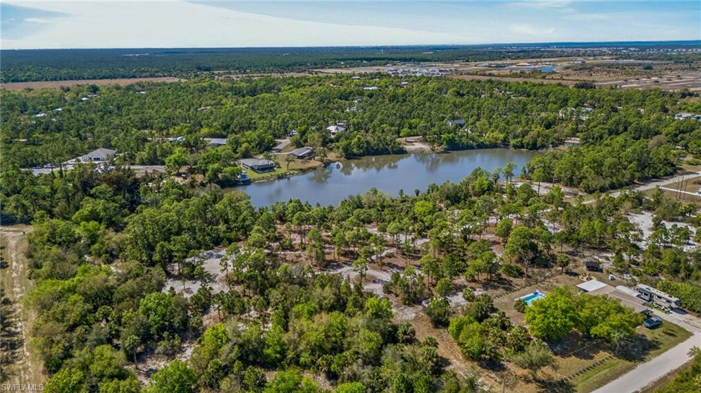 Aerial view of a heavily wooded area and a nearby body of water