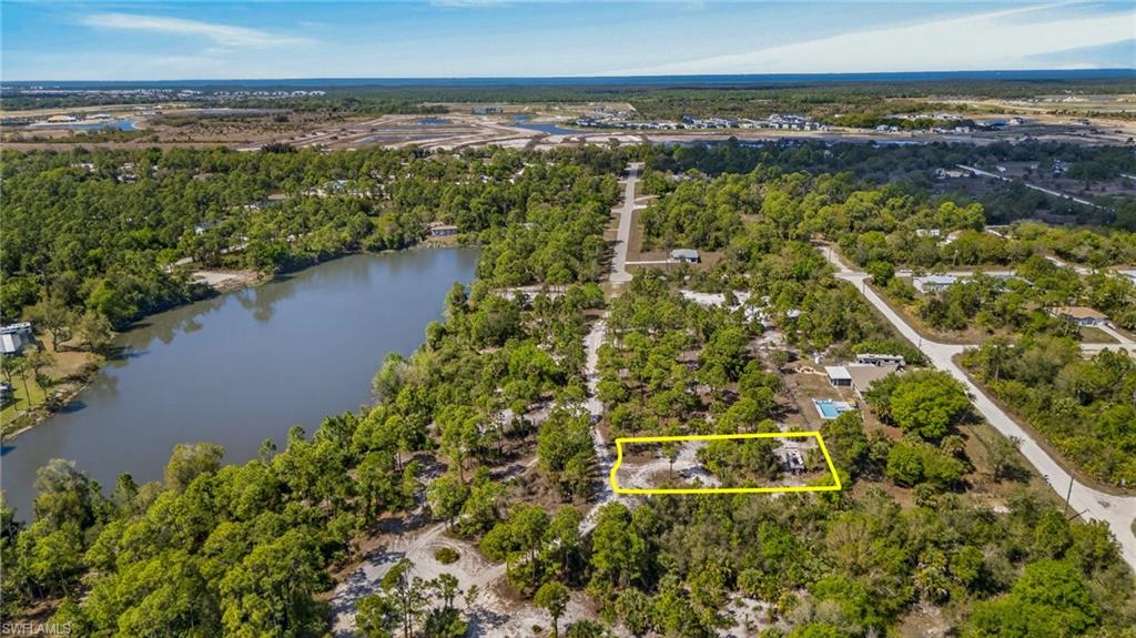 Aerial overview of property's location with property parcel outlined and a nearby body of water