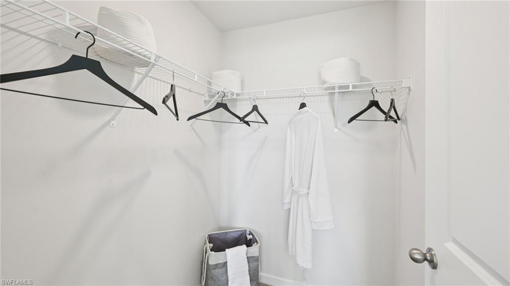 Model Home. Closet with white wire shelving and hanging rods