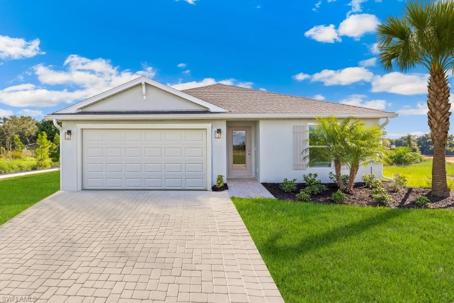 Model Home. Single-story residence featuring a paver driveway, an attached two-car garage, and a covered entryway