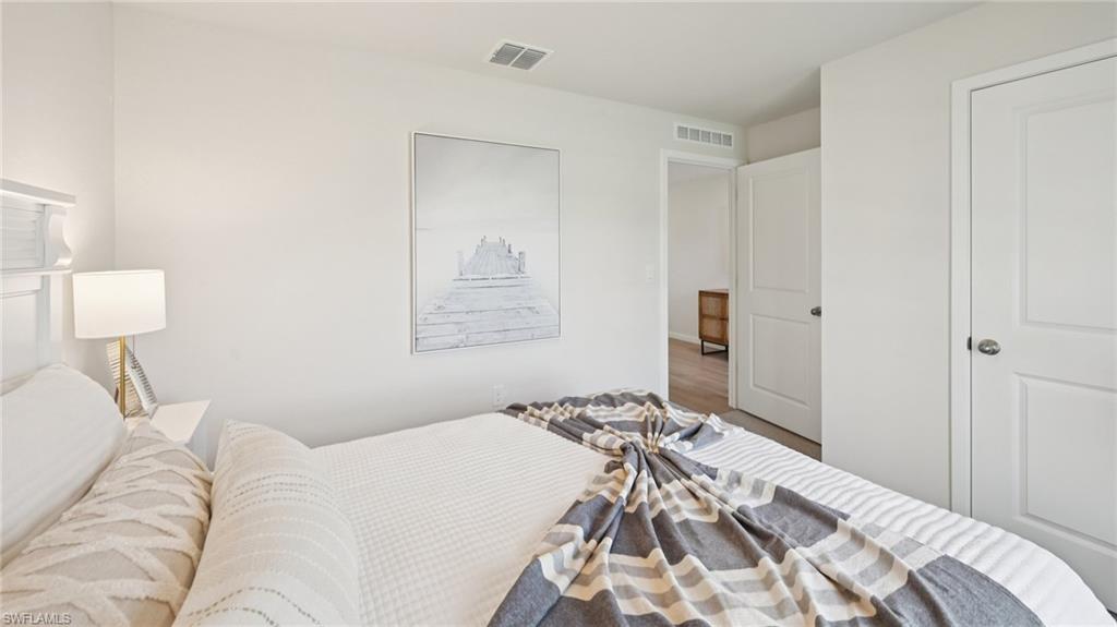Model Home. Bright interior space featuring light-colored walls, a white door with a circular handle, and light-colored flooring visible in the background