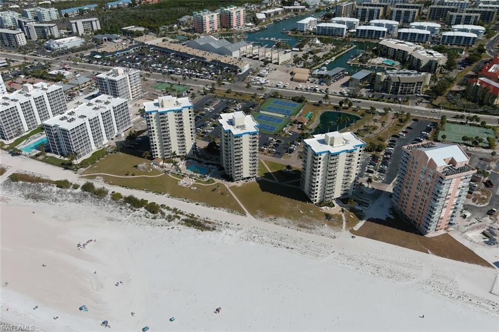 Three tall bldgs  blue stripe on top,  beach front