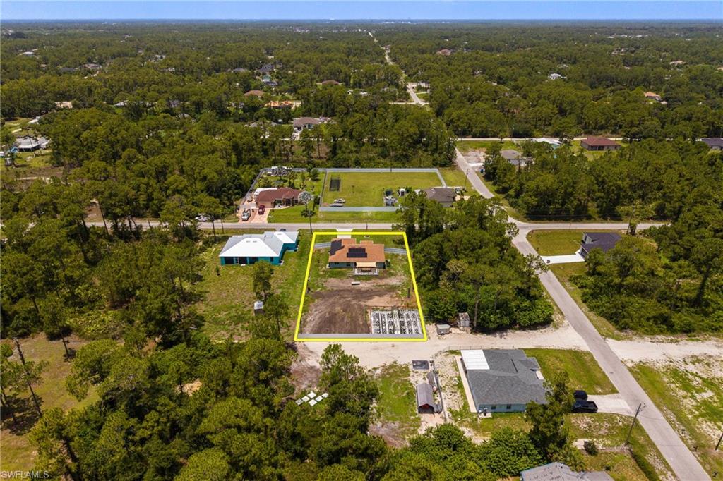 Aerial perspective showcasing a parcel of land marked by a yellow boundary