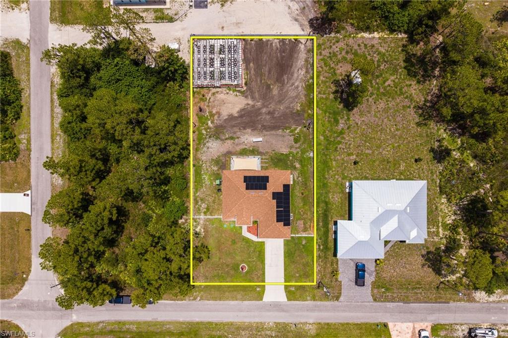 Single-story residence featuring a terracotta-colored tile roof and solar panels