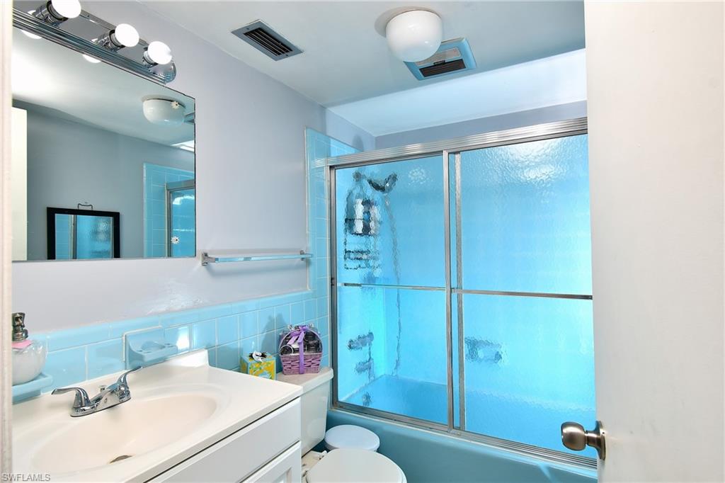 Bathroom featuring a vanity with an integrated sink, chrome faucet, and mirrored medicine cabinet