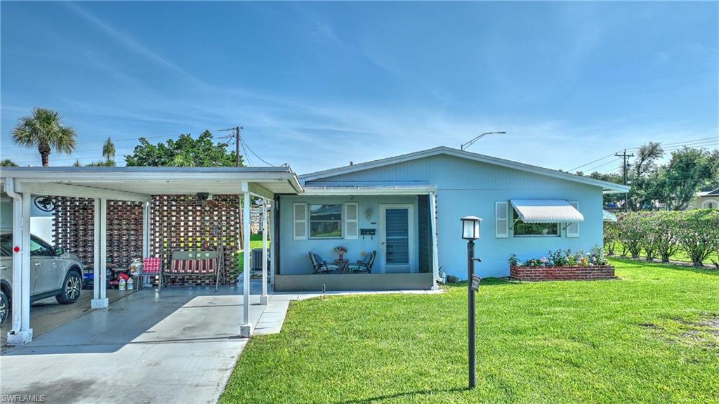 Light blue exterior with white shutters and a front porch