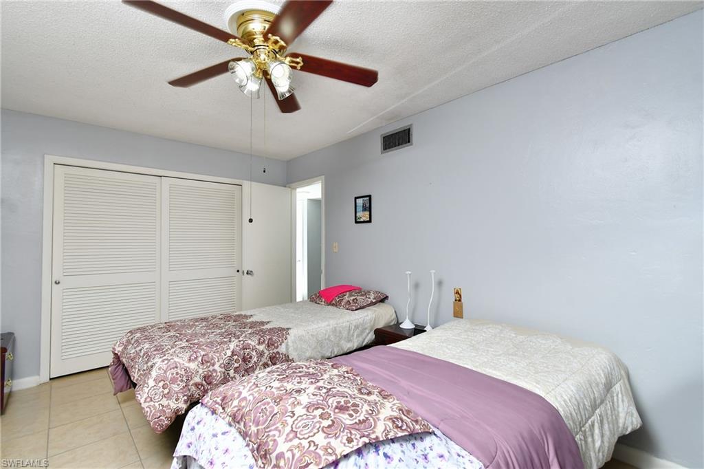 Interior space featuring light blue walls, a textured white ceiling, and light-toned tile flooring