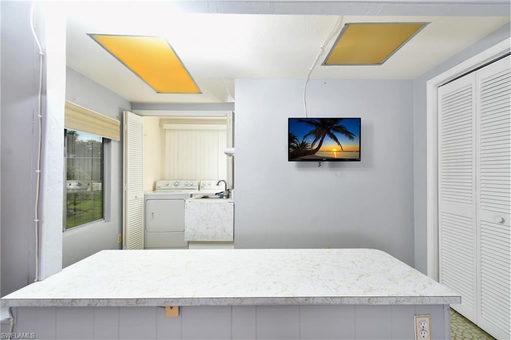 The spacious laundry room includes a utility sink