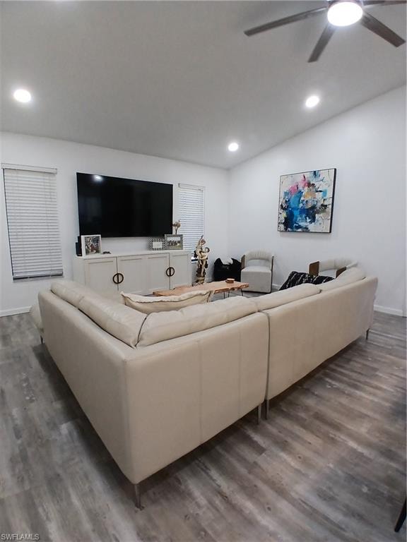 Spacious living area featuring neutral walls and wood-finish flooring