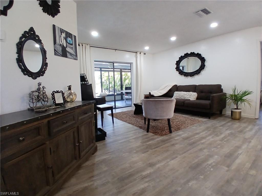 Spacious interior featuring wide plank wood-finish flooring and recessed ceiling lights