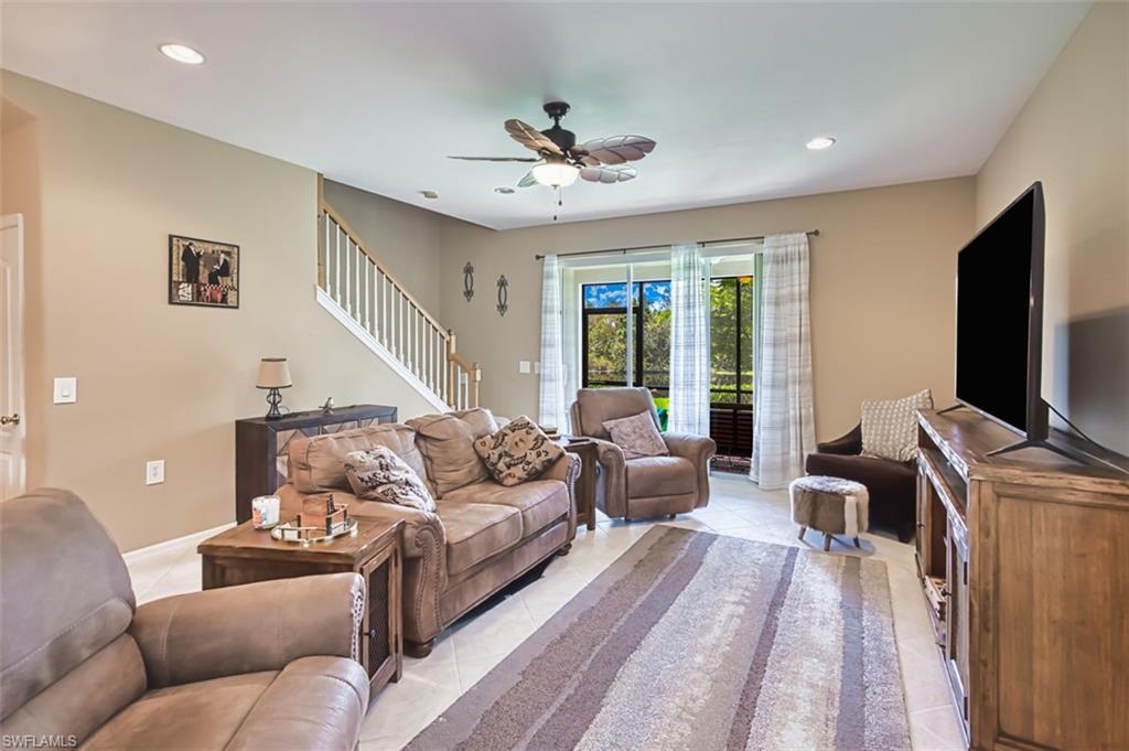 Living area featuring neutral wall tones, recessed lighting, and tile flooring