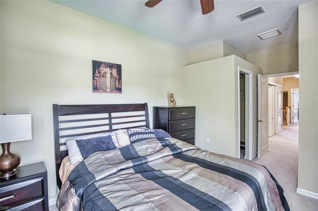 Carpeted bedroom featuring a ceiling fan, recessed lighting, and a closet with a bifold door
