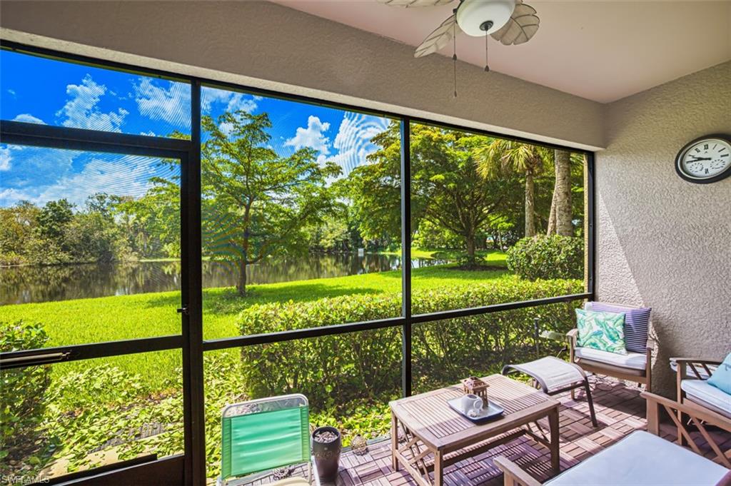 Screened patio featuring a ceiling fan and textured wall finish