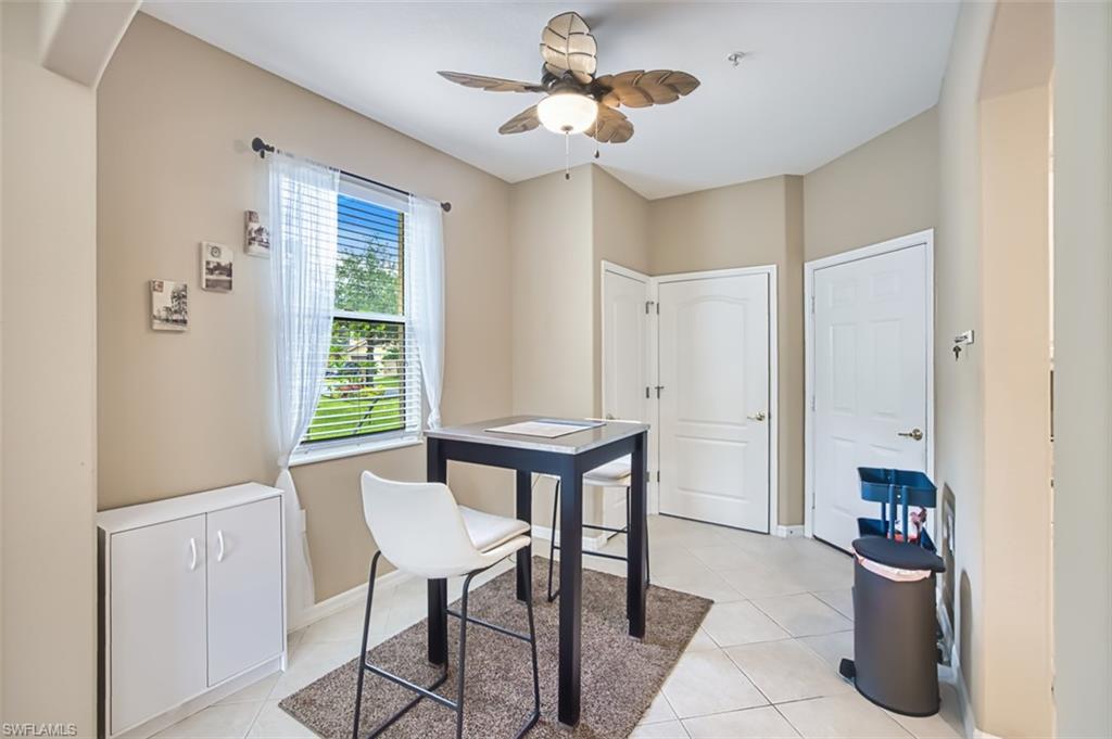 Neutral-toned interior featuring tiled flooring and a ceiling fan with integrated lighting