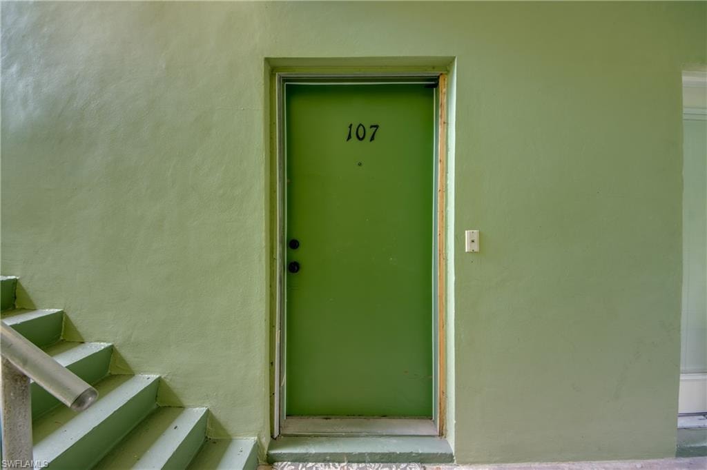 Green painted entry door with unit number 107