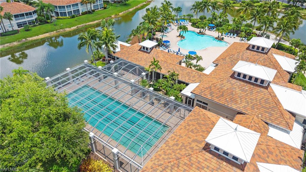 Expansive outdoor aquatic amenities feature a screened lap pool, a lagoon-style pool, and multiple sunning decks