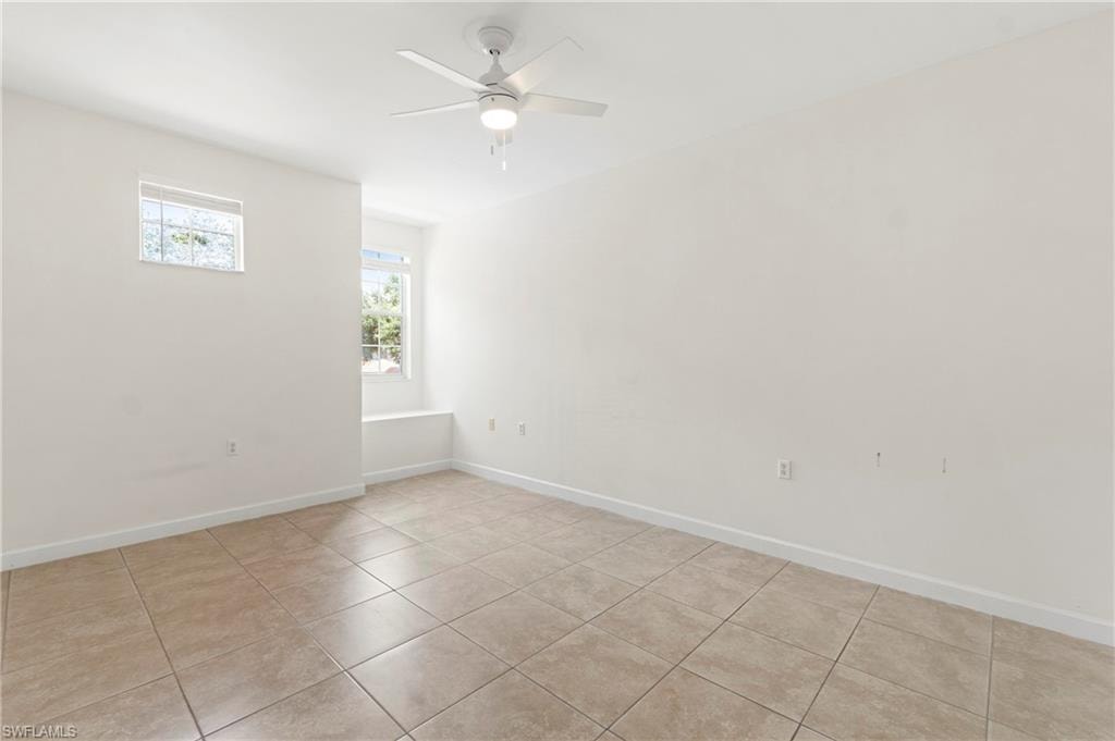 Neutral-toned tile flooring complements bright white walls and trim