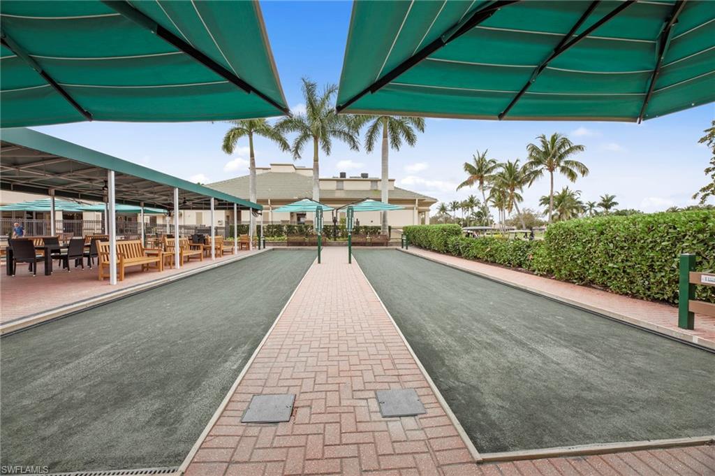 Dual bocce ball courts featuring paver walkways and covered seating areas