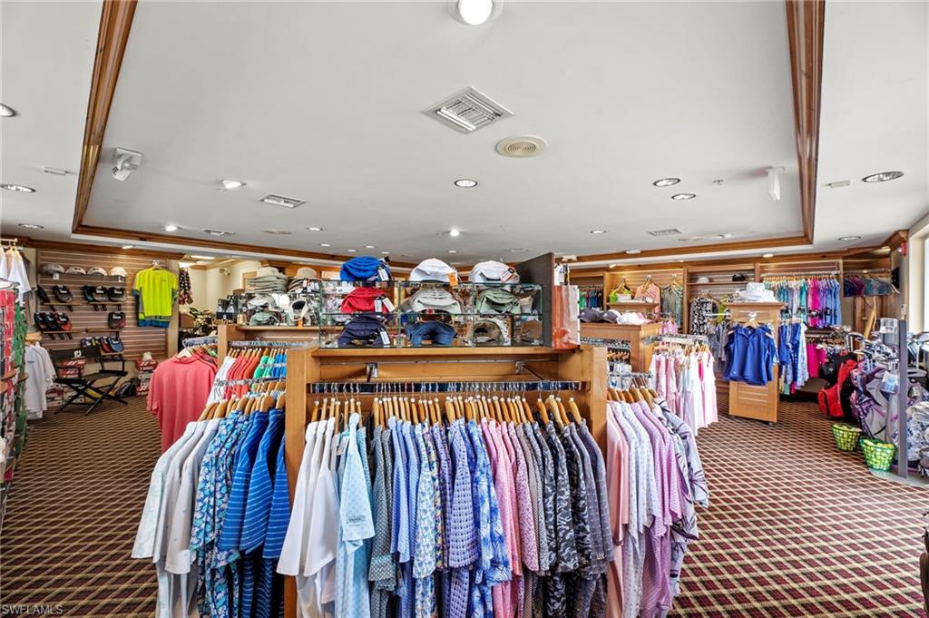 Retail interior featuring extensive merchandise displays, recessed lighting, and a patterned carpet
