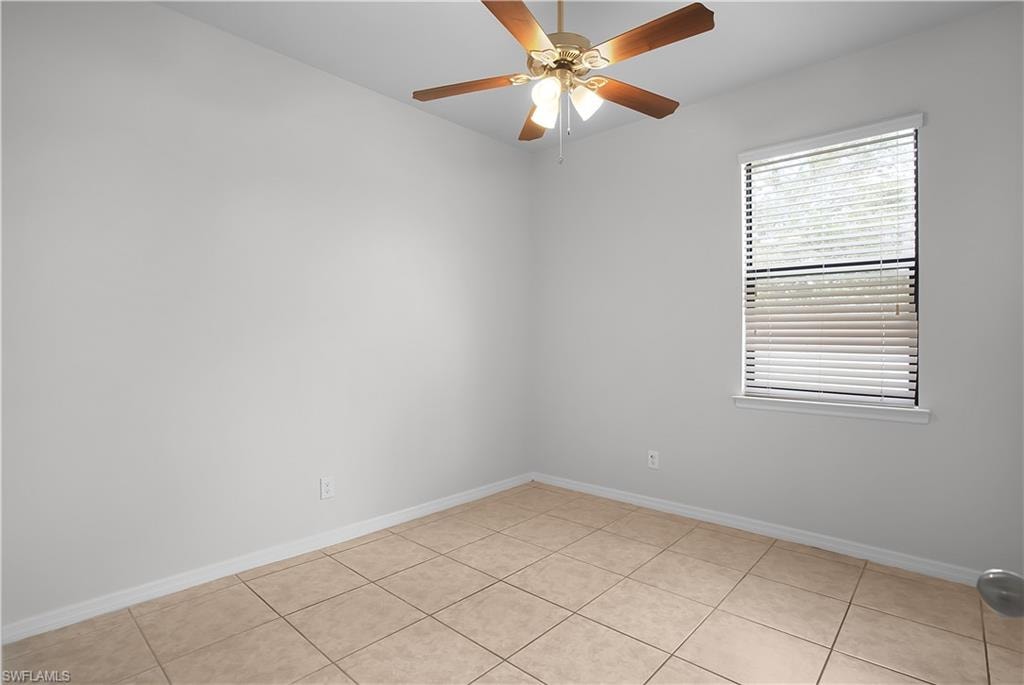 Room featuring square ceramic tile flooring, a single window with blinds, and a ceiling fan with integrated lighting
