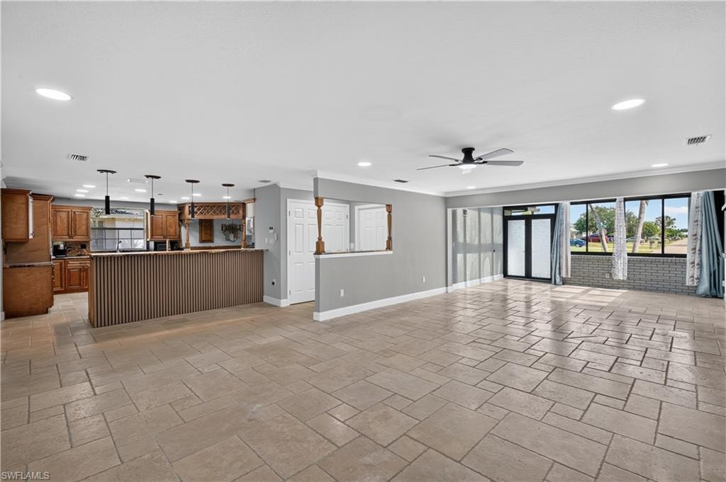 Spacious open-concept living area featuring large format tile flooring and recessed lighting