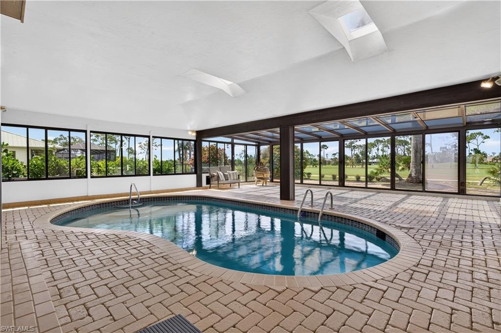 Indoor swimming pool featuring a curved design and integrated pool steps