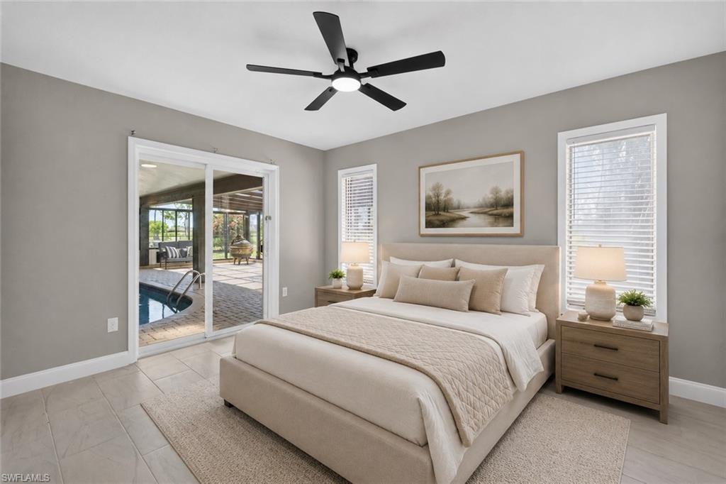Spacious bedroom featuring tile flooring and direct access to a private screened-in pool area via sliding glass doors, virtually staged