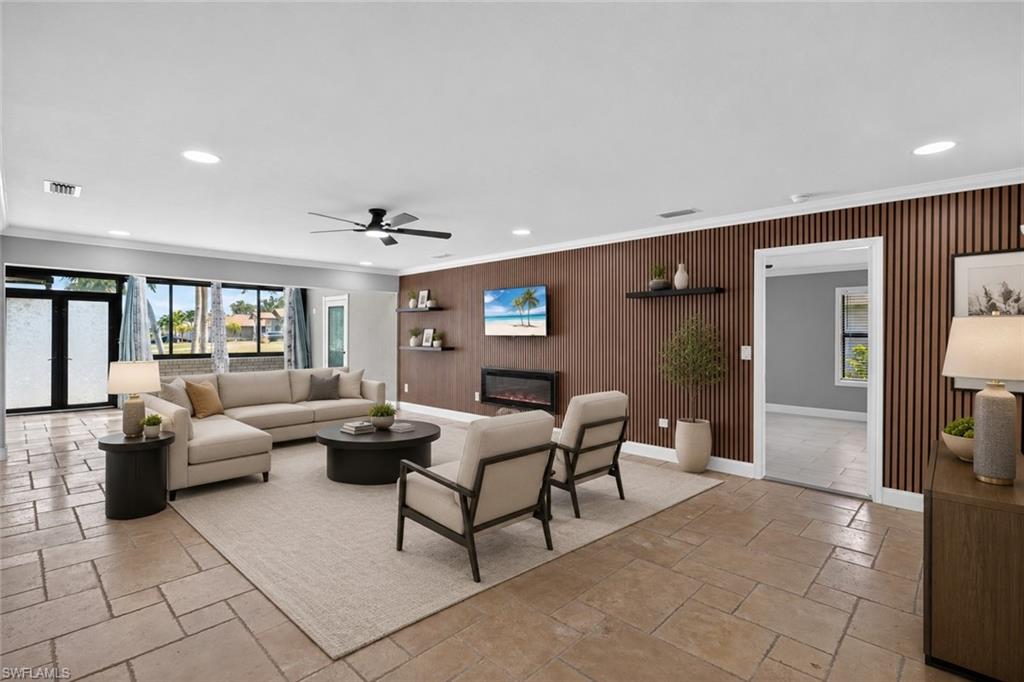 Spacious living area featuring large format tile flooring, a slatted accent wall, recessed lighting, and an electric fireplace, Virtually Staged