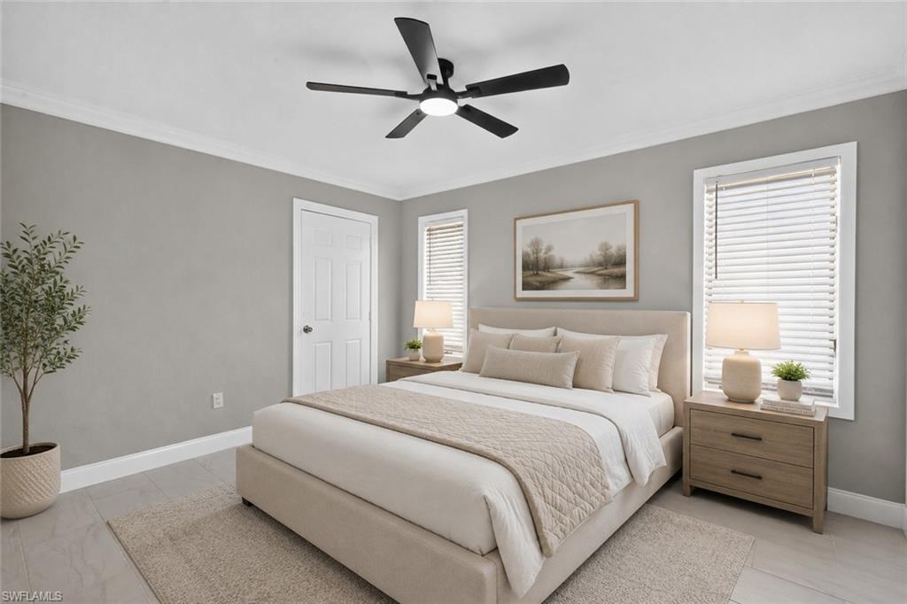 Spacious bedroom featuring light gray walls, white crown molding, and two windows with white blinds, virtually staged